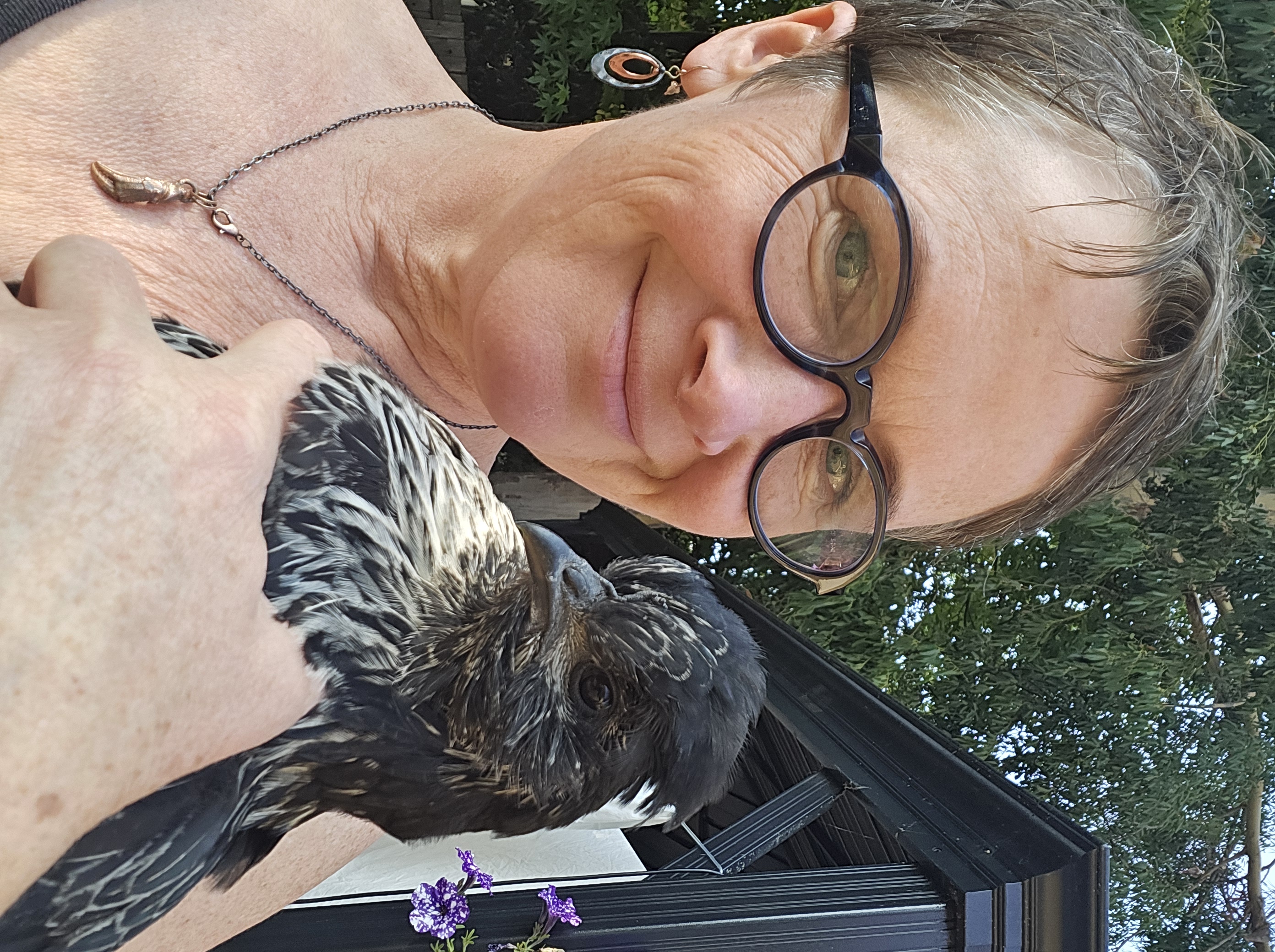 Christine Samson holding a chicken outdoors