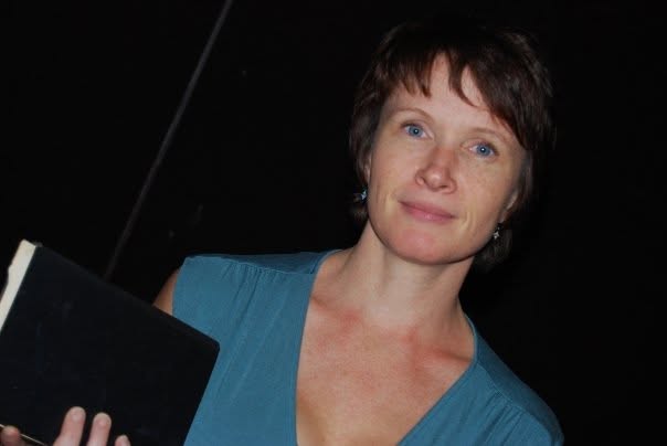 Christine Samson holding an open script at Sacramento High School