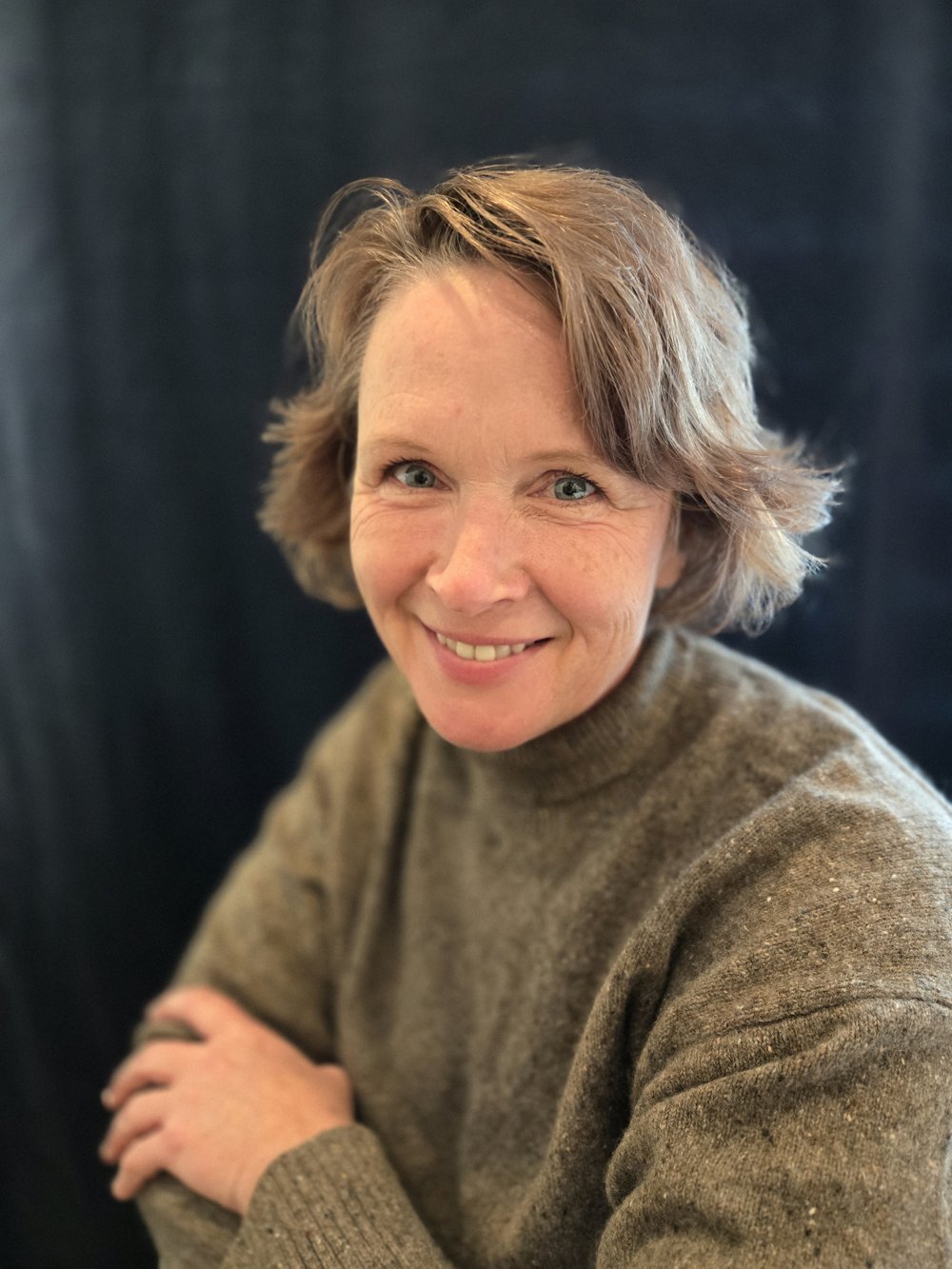 Christine Samson smiling, wearing a grey sweater