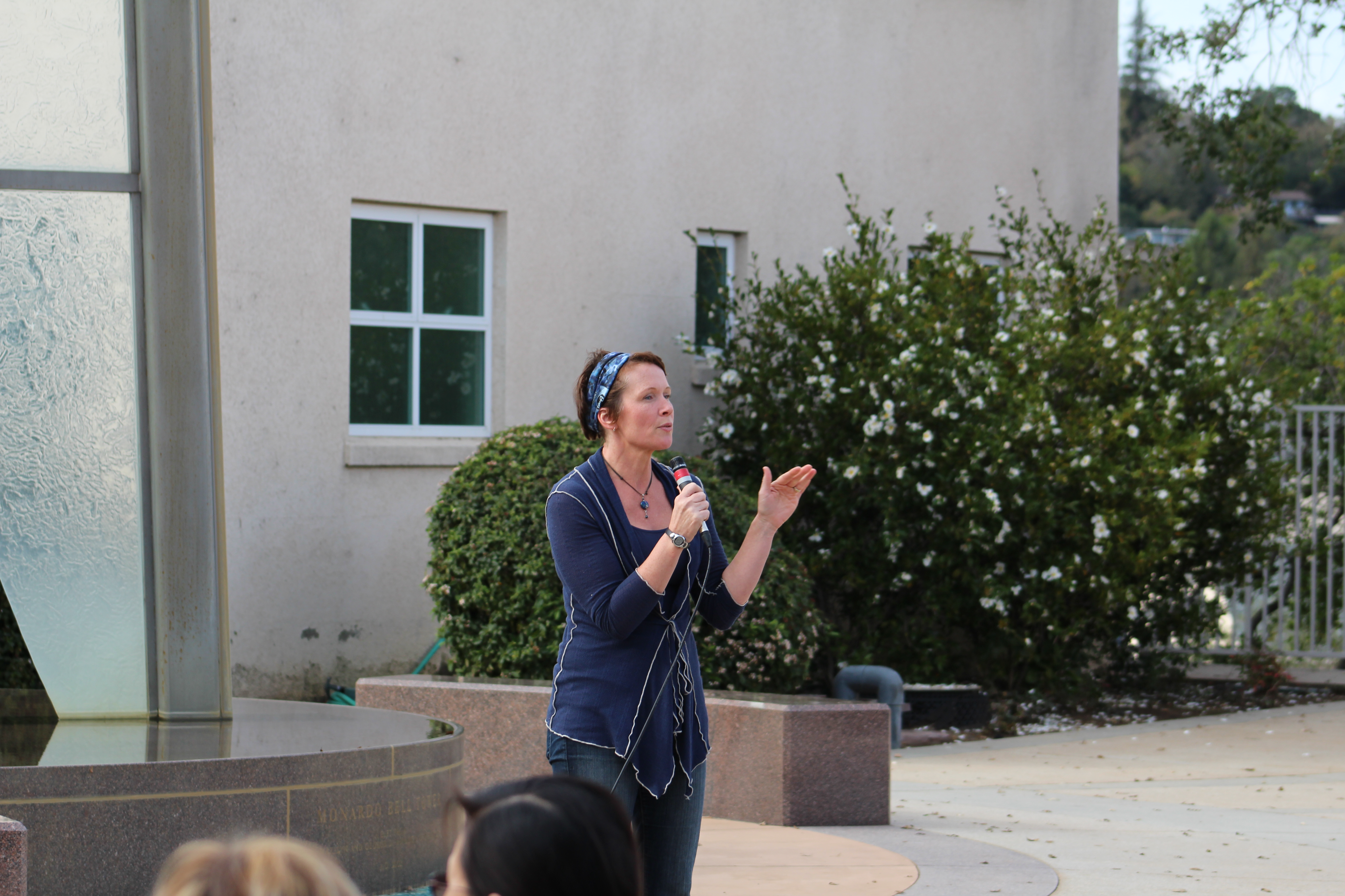 Christine Samson introducing Romeo and Juliet beside the fountain at Marin Catholic High School